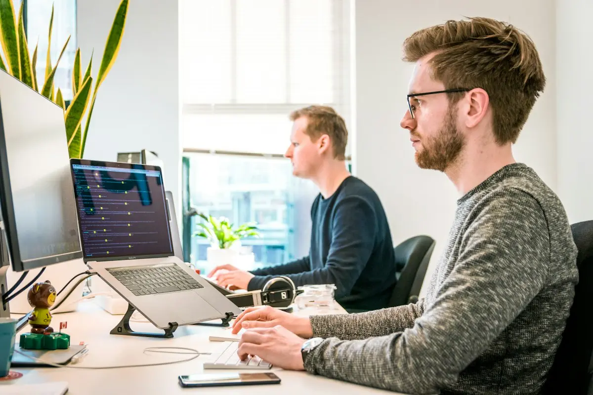 Two colleagues working at their computers